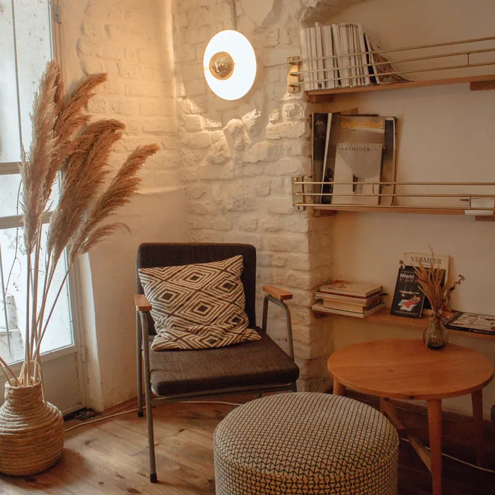 Quiet reading corner with an armchair, books and soft daylight