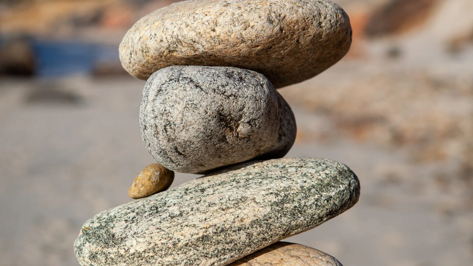 Balanced stack of smooth stones on a quiet beach